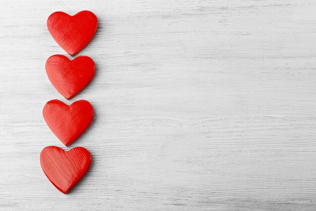 Wooden hearts on light background