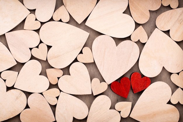 Wooden hearts, one red heart on the wooden heart