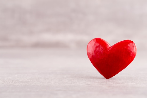 Wooden hearts pattern, one red heart on the wooden heart background
