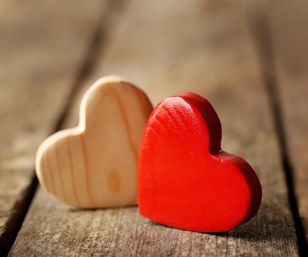 Wooden hearts on rustic wooden background