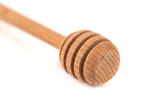 Wooden honey dipper isolated over white background.