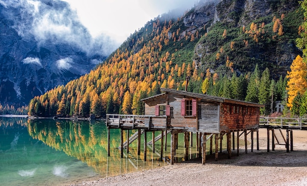 Wooden house by lake and mountain