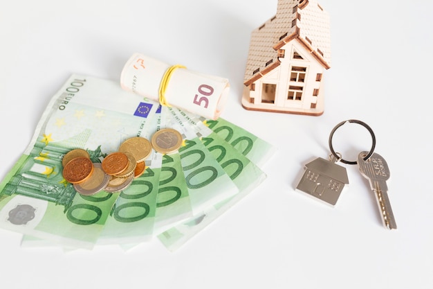 Wooden house and cash on table