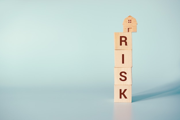 Wooden house on cubes with word risk