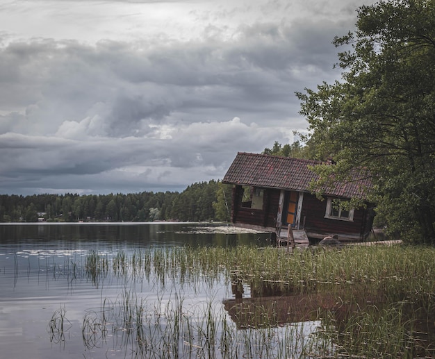 wooden house on the lake shore