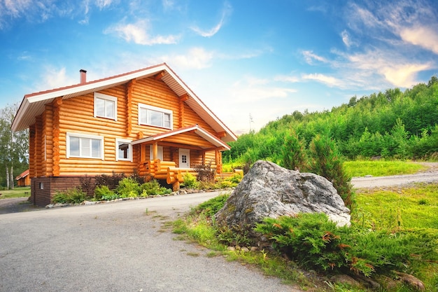 Wooden house on the lawn with stone