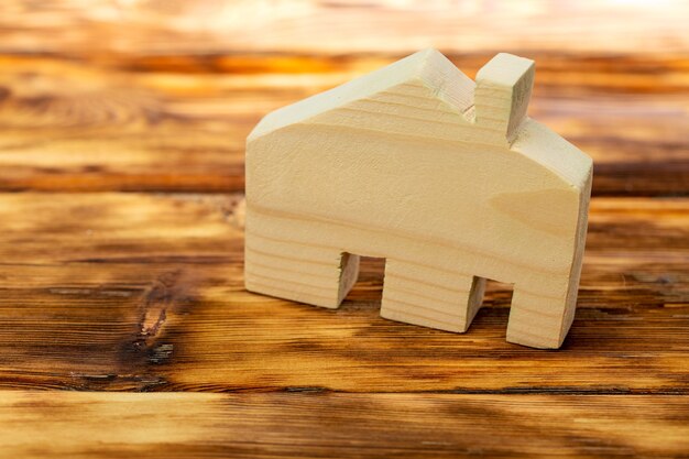 Wooden house miniature on wooden surface