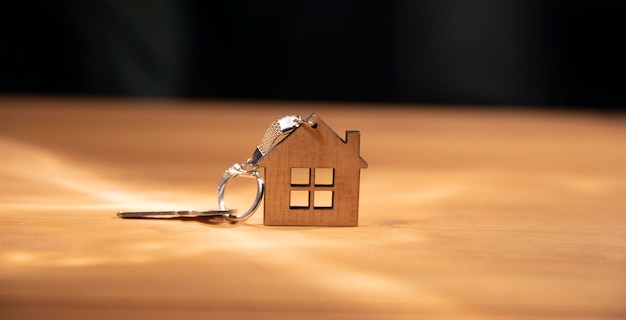 Wooden house model and key on the table