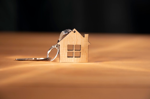 Wooden house model and key on the table