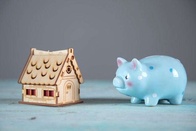wooden house model and piggy bank