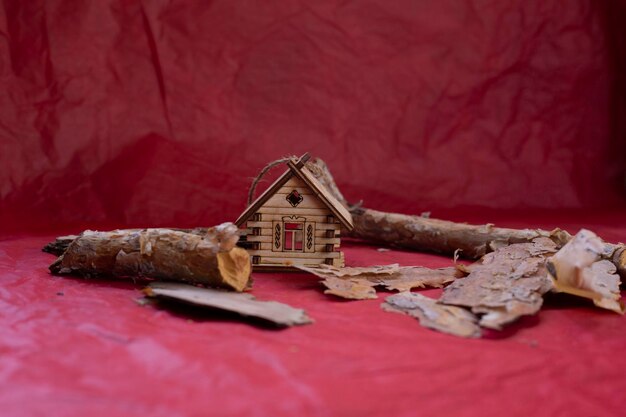 Wooden house model on red background