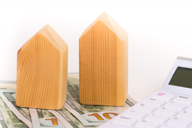 Wooden house model with dollars banknotes