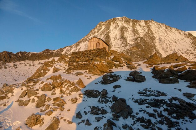 A wooden house in the mountains at sunset in the French Alps