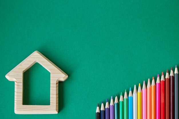 Wooden house and pencils 