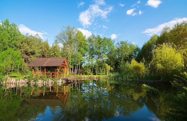 Wooden house and pond at the sunrise