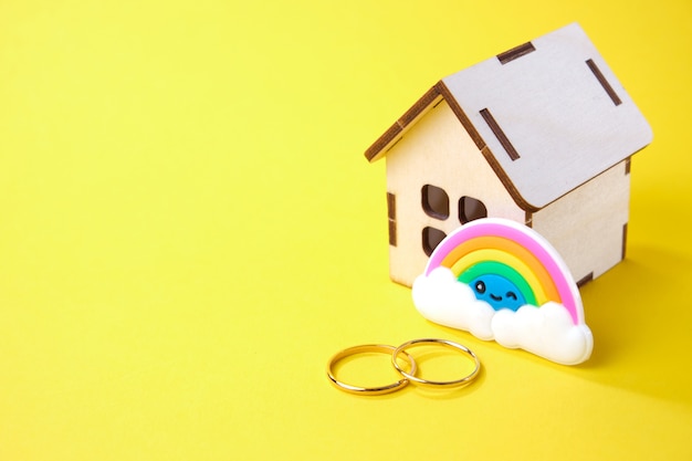 Wooden house wedding rings and rainbow