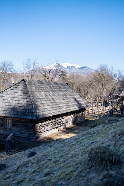 A wooden house with a mountain in the background