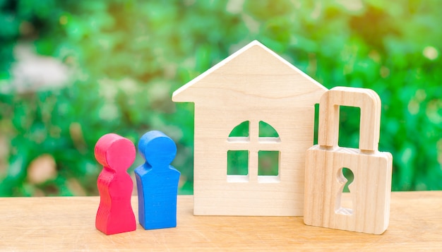 A wooden house with a padlock and a young pair of lovers. 