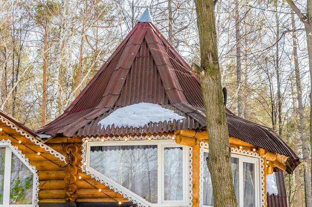 A wooden house with a red roof and a window with the word no on it.