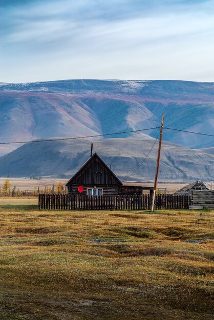 Wooden house with satellite TV antenna KyzylTash village KoshAgach district Altai Russia