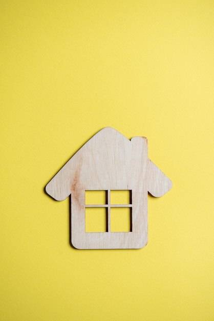 Wooden house on yellow background