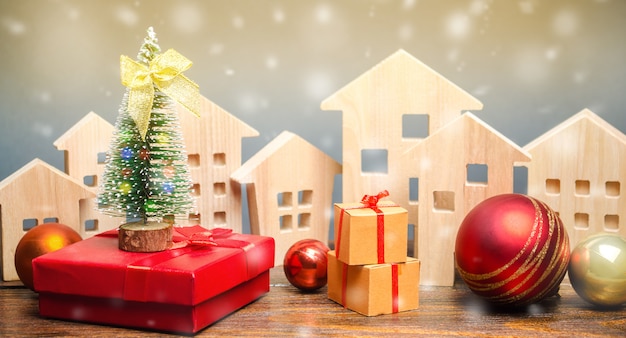 Wooden houses, Christmas tree and gifts.