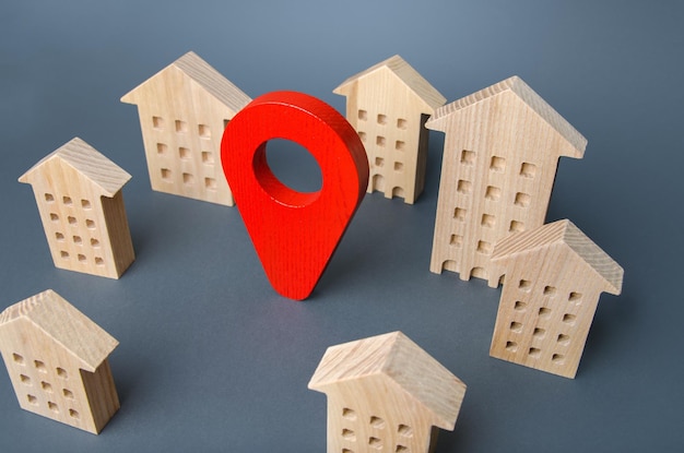 Wooden houses and a red location pin Location accessibility to infrastructure Residential complex Navigation and orientation within city Business advertising Tracking Moving to different city