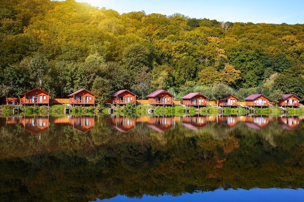 잉어 낚시를 위한 숲 근처 물 위의 목조 주택