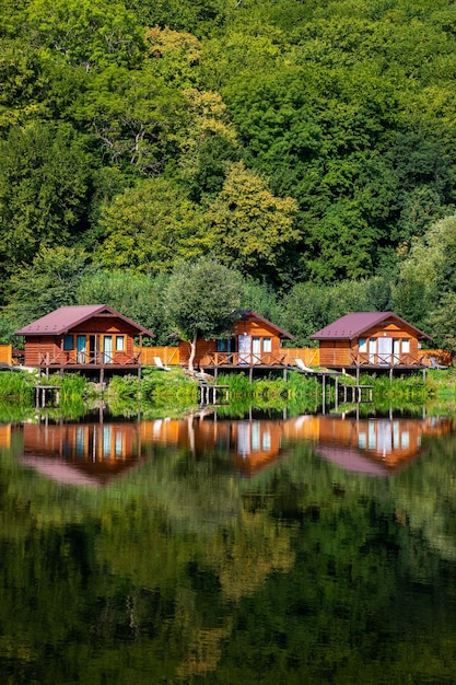 Wooden houses on the water near the forest for outdoor recreation A place for fishing and hunting