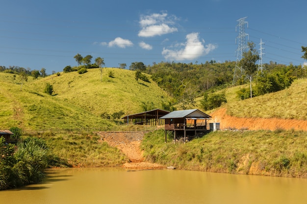 Wooden hut near the pond, peasant hut, Laos