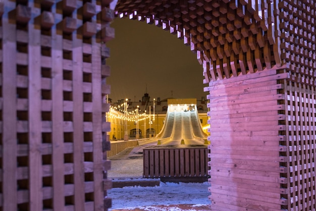 Wooden ice slide for tubing in the city of St Petersburg Night view Christmas and New Year holidays in the park
