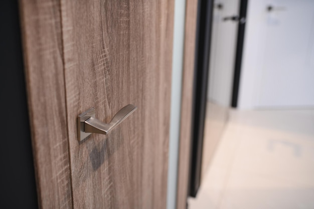wooden interior door with emphasis on metal handle close up of door handle on interior door
