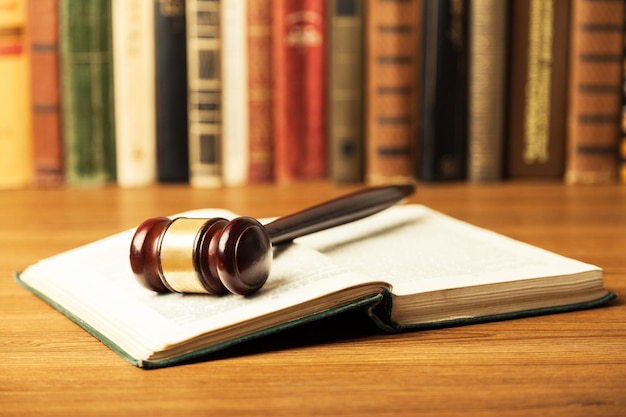 Wooden judge gavel and book on table