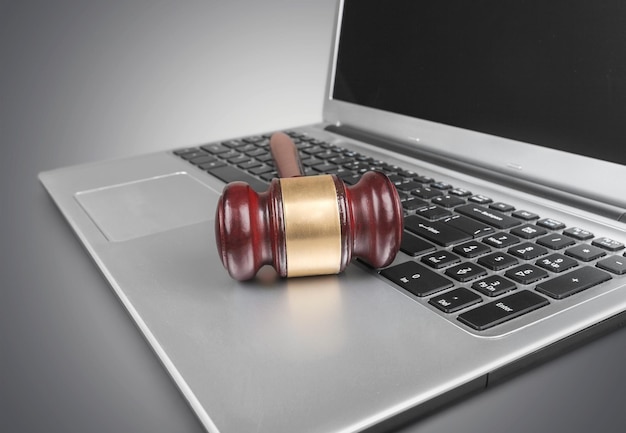 Photo wooden judge gavel on laptop keyboard