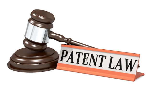 Wooden judge gavel and patent law banner