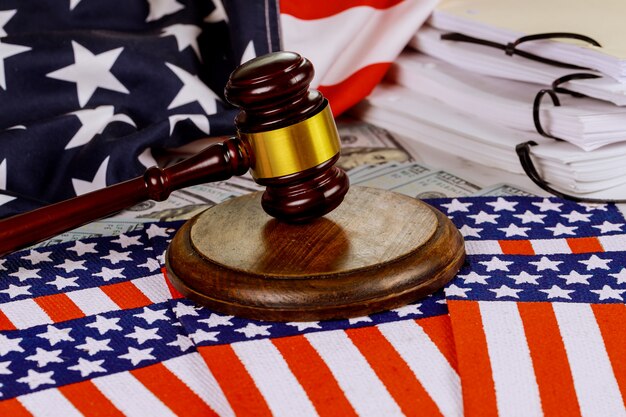 Деревянный молоток судьи на американском флаге Справедливость и закон