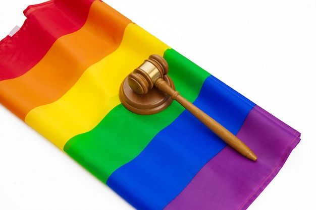 Wooden judge mallet and lgbt rainbow flag isolated. Law and lgbt