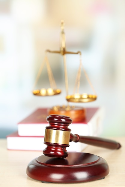 Wooden judges gavel on wooden table, close up