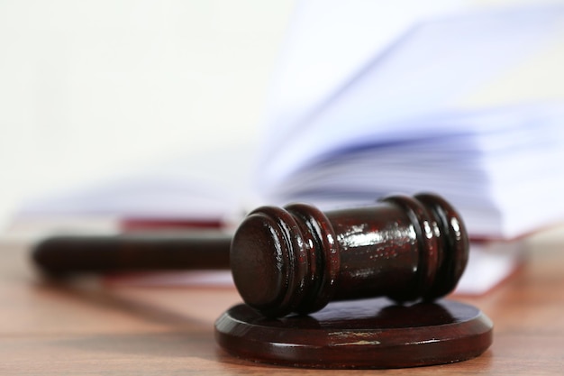 Wooden judges gavel on wooden table close up