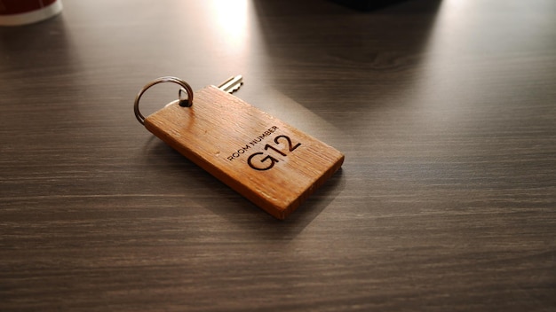 Wooden keychain laser cutting letter number G12 on wood table