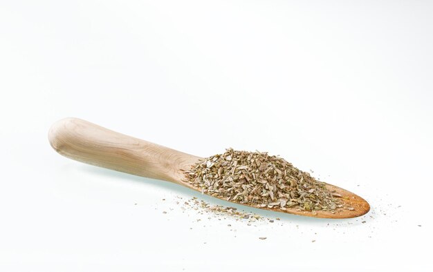 Wooden kitchen spatula with dry seasoning on a white background with reflection