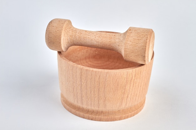 Wooden kitchen utensil isolated on white. Mortar and pestle.