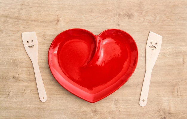 Wooden kitchen utensils and red tablecloth Funny tools