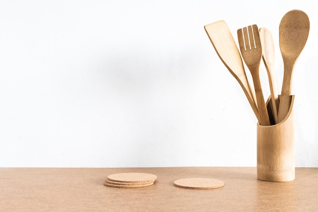 Wooden kitchen utensils on wood background desk