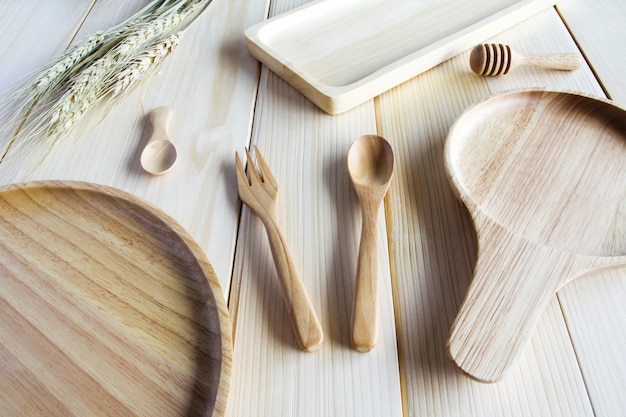 Wooden kitchen utensils on wooden background