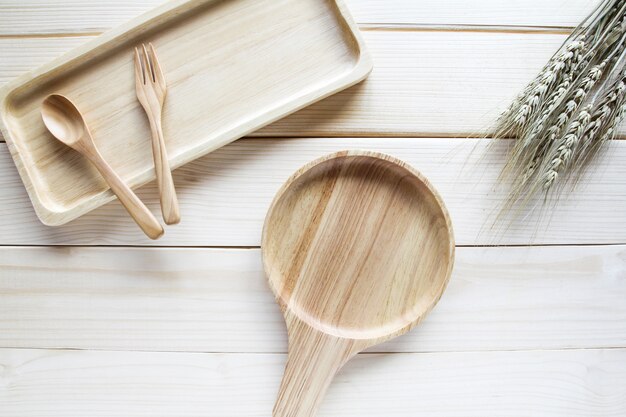 Wooden kitchen utensils on wooden background