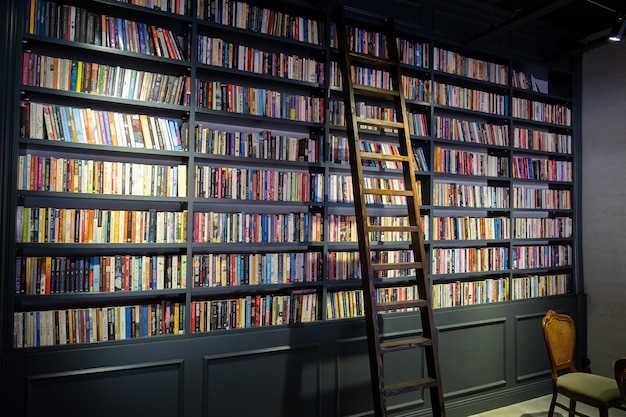 Wooden ladder standing on bookshelf