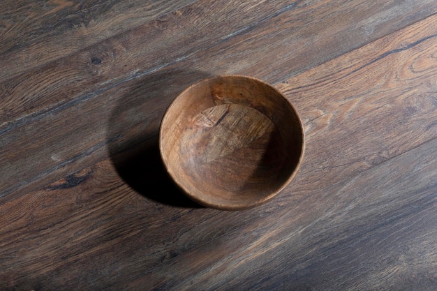 Wooden laminate parquet floor with texture and bamboo wooden empty bowl