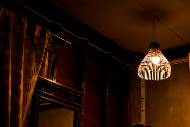 The wooden lamp hanging in a wooden house