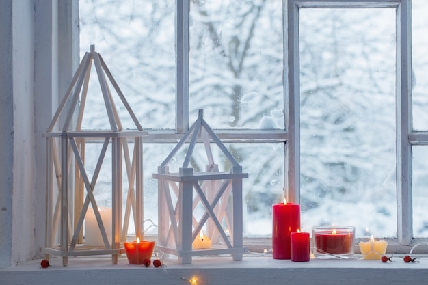 Wooden lantern on windowsill on wall winter landscape